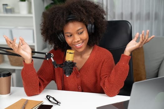 Host channel of beautiful African woman talking in online broadcast teaching marketing influencer, with listeners in broadcast or online. Concept of anywhere at work place. Tastemaker.