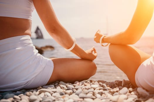 Woman sea yoga. Back view of free calm happy satisfied woman with long hair standing on top rock with yoga position against of sky by the sea. Healthy lifestyle outdoors in nature, fitness concept.