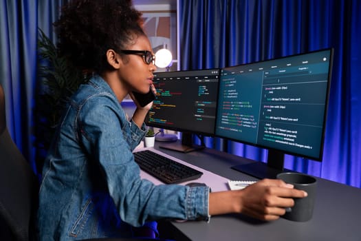 Young African American IT developer concentrating on monitor screen laptop with codding program in data of application and website, Concept of creating innovative html updated version. Tastemaker.