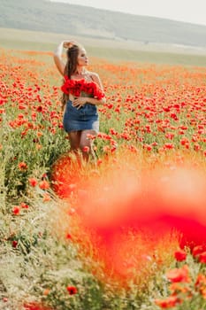 Woman poppies field. portrait of a happy woman with long hair in a poppy field and enjoying the beauty of nature in a warm summer day