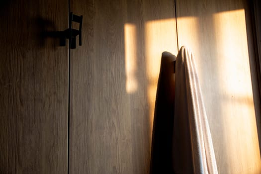 White towels hanging on wardrobe.