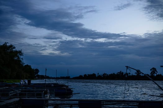 Fish farming by the river sundown view in the evening time with cloudy.