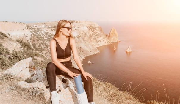 Fitness woman sea. Outdoor workout on yoga mat in park near to ocean beach. Female fitness pilates yoga routine concept. Healthy lifestyle. Happy fit woman exercising with rubber band in park.