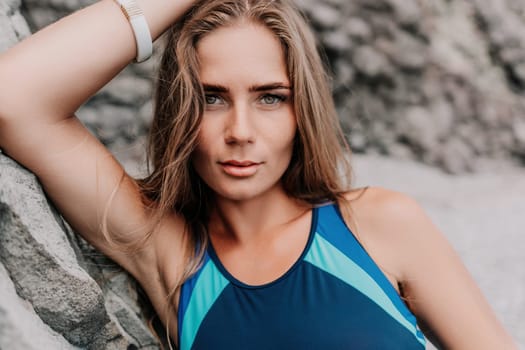 Woman travel sea. Young Happy woman in a long red dress posing on a beach near the sea on background of volcanic rocks, like in Iceland, sharing travel adventure journey