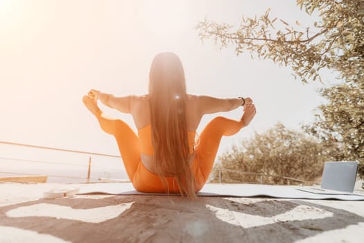 Fitness woman sea. Outdoor workout on yoga mat in park near to ocean beach. Female fitness pilates yoga routine concept. Healthy lifestyle. Happy fit woman exercising with rubber band in park.