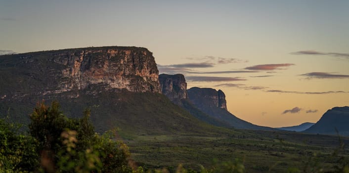 Morning light reveals peaceful cliffs and nature, creating a calm and grand setting.