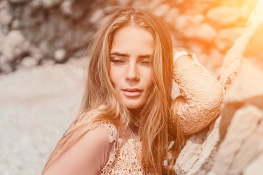 Woman travel sea. Young Happy woman in a long red dress posing on a beach near the sea on background of volcanic rocks, like in Iceland, sharing travel adventure journey