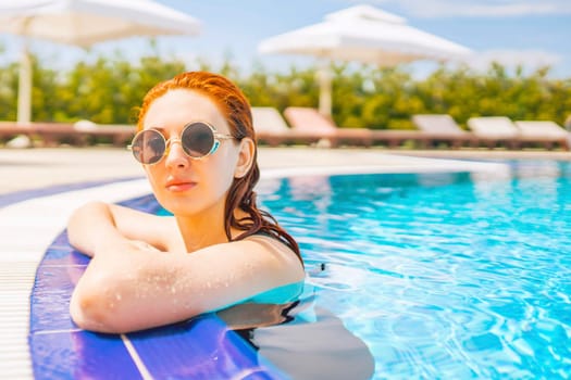 Woman swimming in the pool. Woman relaxing in swimming pool.