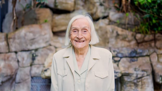 Portrait of a great grandmother smiling at camera in a nursing home