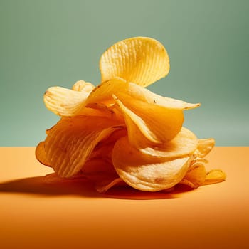 Exploding stack of crispy potato chips against dark background