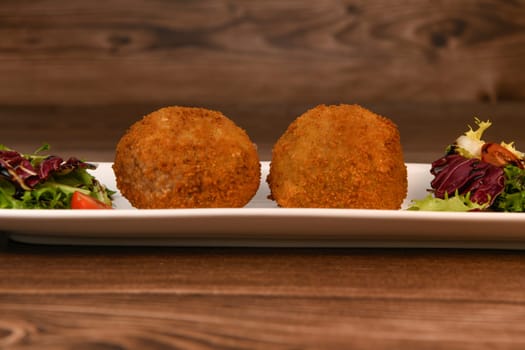 RECIPE FOR BREADED BEEF MEATBALLS STUFFED WITH A SOFT BOILED EGG. High quality photo