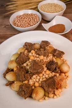 Moughrabieh is a popular dish in the Lebanese cuisine, LEBANESE RECIPE FOR MOUGHRABIEH WITH BEEF AND SMALL ONIONS, SEMOLINA PEARLS AND CHICKPEAS. High quality photo