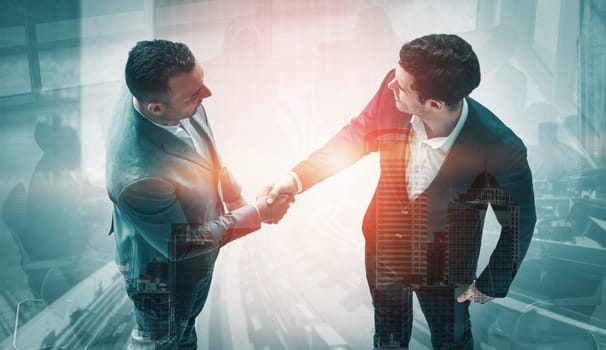 Double exposure image of business people handshake on city office building in background show partnership success of business deal. Concept of corporate teamwork, trust partner and work agreement. uds