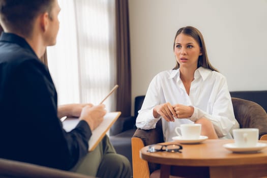 Psychological consultation gaining improvement on mental problem, happy young female patient doing therapy session while psychiatrist making diagnostic on mental illness. Unveiling