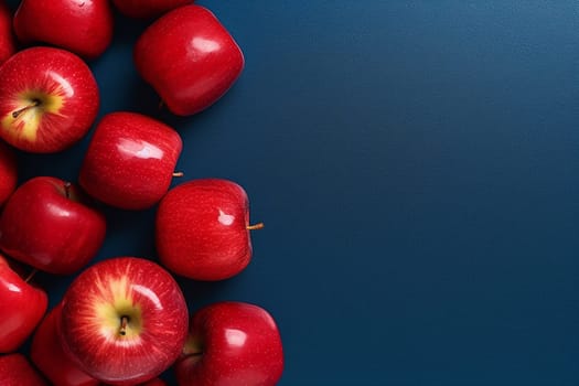 Fresh red apples arranged neatly on a dark blue background.