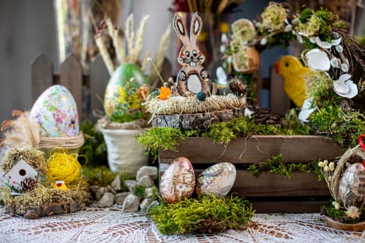 elements that evoke the spirit of the holiday. On a bed of vibrant green moss, two intricately decorated Easter eggs adorned with letter and number motifs rest delicately.