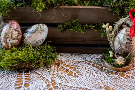 Embark on a visual journey through this captivating Easter composition, where lush green moss serves as a canvas for two intricately decorated eggs adorned with letters and numbers.