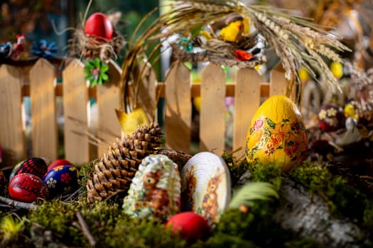 In this captivating Easter scene, a bed of moss adorned with birch bark, twigs, and vibrant Easter eggs creates a wonderland.