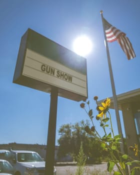 Political Issue Image Of A Sign For A Gun Show In A Southern State In The USA, Complete With Flag