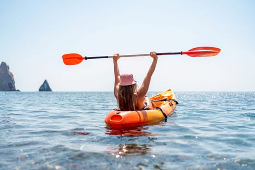 Kayak sea woman. Happy attractive woman with long hair in red swimsuit, swimming on kayak. Summer holiday vacation and travel concept