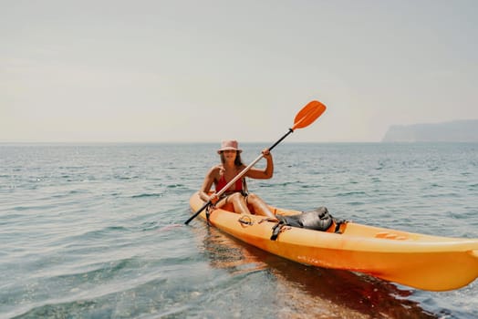 Kayak sea woman. Happy attractive woman with long hair in red swimsuit, swimming on kayak. Summer holiday vacation and travel concept