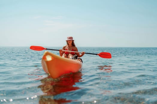 Kayak sea woman. Happy attractive woman with long hair in red swimsuit, swimming on kayak. Summer holiday vacation and travel concept