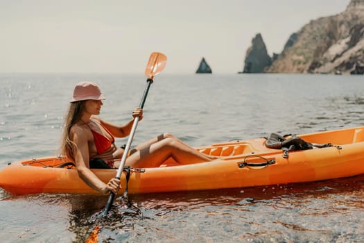 Kayak sea woman. Happy attractive woman with long hair in red swimsuit, swimming on kayak. Summer holiday vacation and travel concept