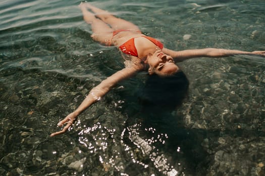 Happy woman sea relaxing floating in transparent sea water on summer holiday. Travel leisure recreation lifestyle, female in nature