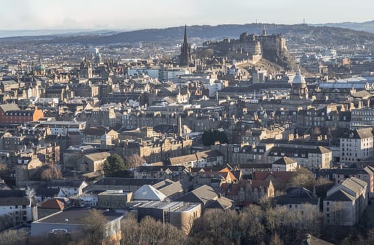 Edinburgh, Scotland - Jan 17, 2024 - Amazing Edinburgh Cityscape and Edinburgh Castle seen from the top of Salisbury Crags. Destinations in Europe, Copy space, Selective focus.