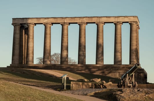 Edinburgh, Scotland - Jan 18, 2024 - A view of the National Monument of Scotland with a bright blue sky in the background situated on Calton Hill at Edinburgh city. Scotland, Space for text, Selective focus.