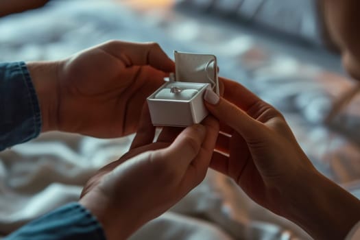 A woman holds an engagement ring in a box, showcasing the symbol of commitment and love.