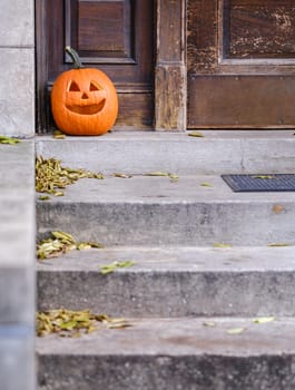 A Carved Pumpkin On A Stoop In A US City For Halloween