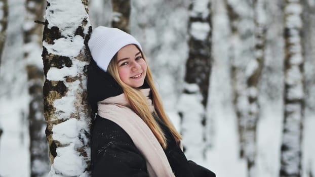 Portrait of a girl in winter in a birch forest