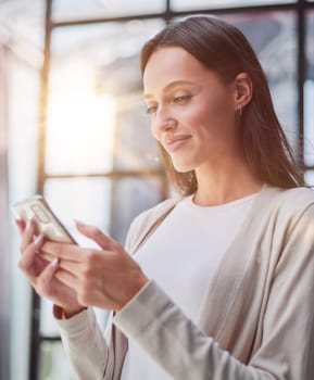 Businesswoman sitting in office, talking on the phone