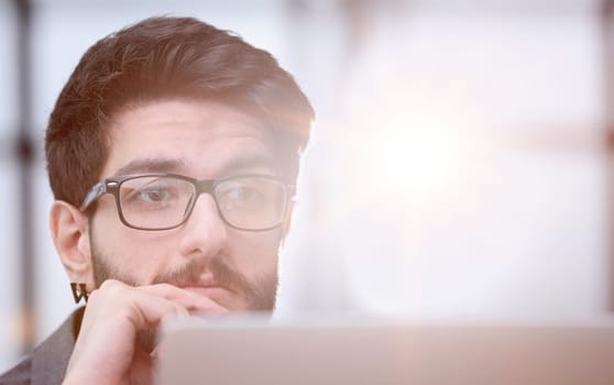 focused young businessman looking at computer monitor