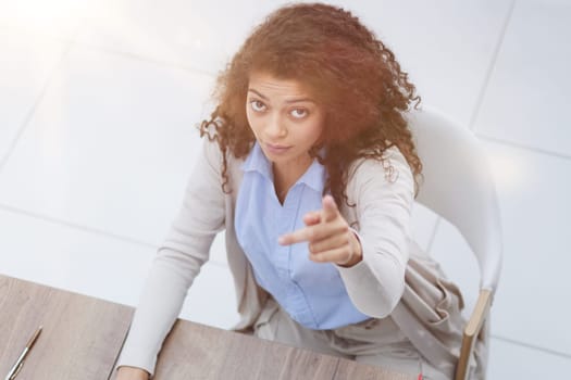 Image of young beautiful joyful woman smiling while working with laptop in office