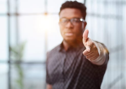 You won't get away with it. Portrait of a businessman pointing his finger to you