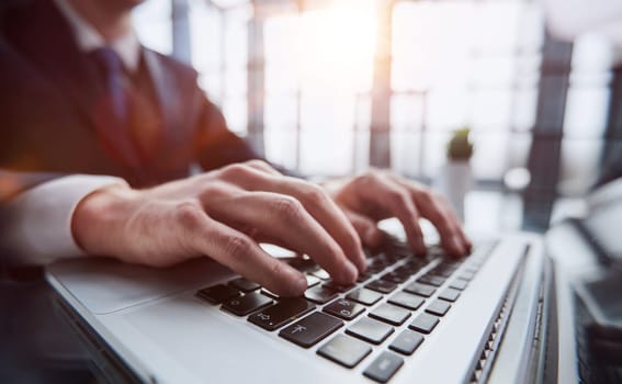 Young man working on computer at table in office, closeup. Banner design