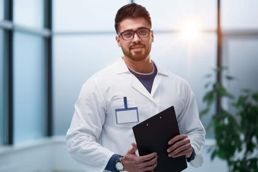 experienced doctor with a folder in his hands in the hospital