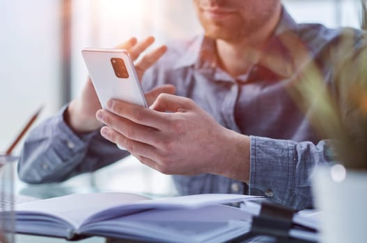 businessman professional executive holding mobile working at desk with smartphone.