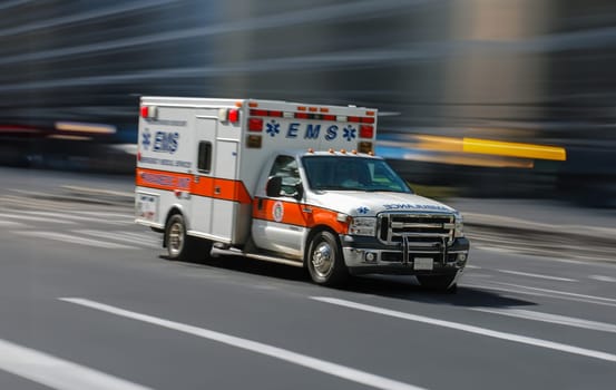 An Ambulance Racing Through A Downtown City Street, With Motion Blur