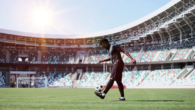 African American man playing football on the stadium field.