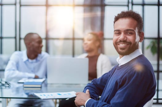 Portrait of African American businessman sitting at desk in an office