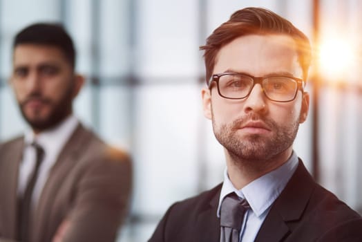 Portrait male worker looking at camera, positive employee posing for company business directory with co-workers