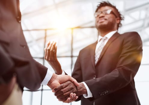 Businessman shaking hands with colleague after meeting in office