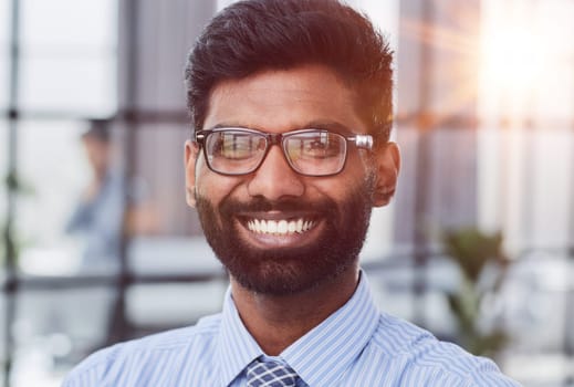 male investor beard looking at camera and smiling in modern office