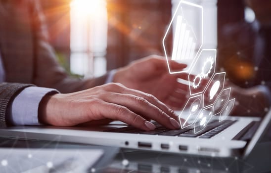 Close-up of male hands using laptop at office