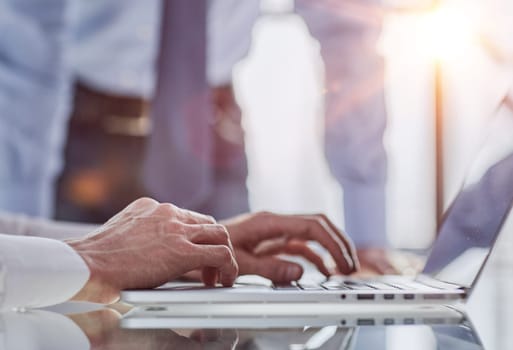 Man hands typing on laptop computer keyboard, close up. E-business, online job.