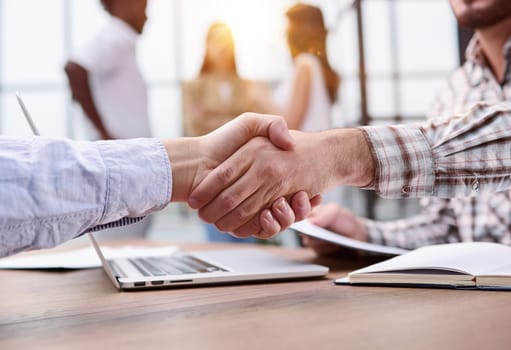 Employee shaking the hand of his manager