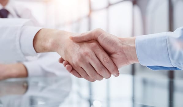 Partners or lawyers shaking hands at a meeting. Teamwork, partnership, success concept.